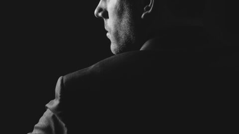 grayscale photo of man wearing blazer