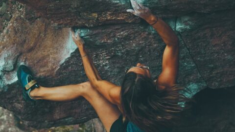 photo of woman climbing mountain