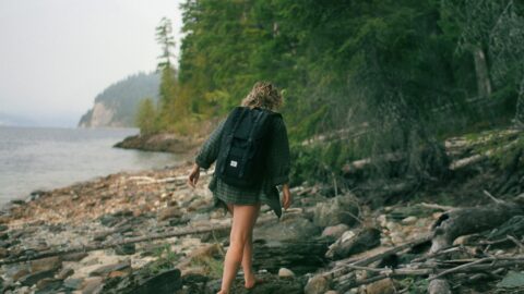 woman walking on rocky seashore